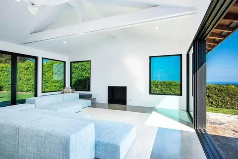 a large bedroom with a large bed and a large window