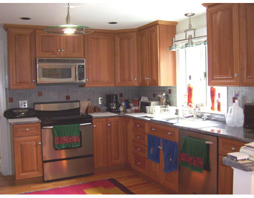 322 Lincoln Street Lexington, MA 02421 - Photo 6 of 9 a kitchen with stainless steel appliances granite countertop a stove a sink and a microwave