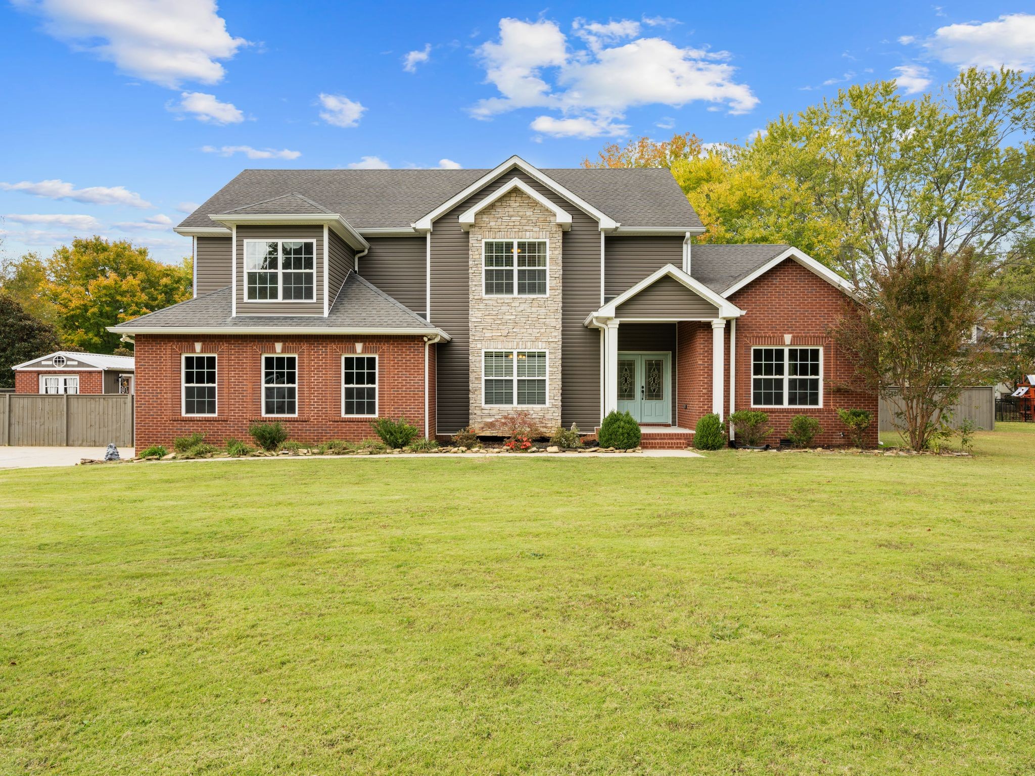 a front view of a house with a garden