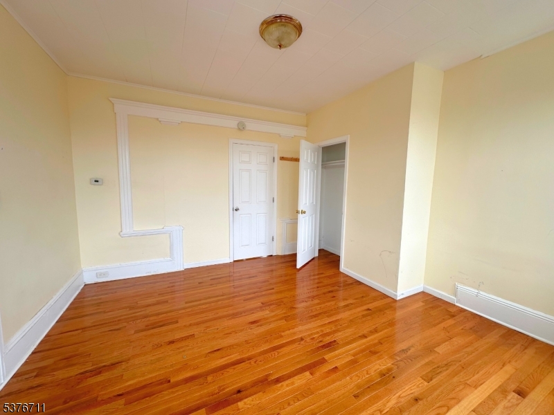 182 Knickerbocker Avenue, Unit 2 Paterson, NJ 07503 - Photo 14 of 14 a view of empty room with wooden floor
