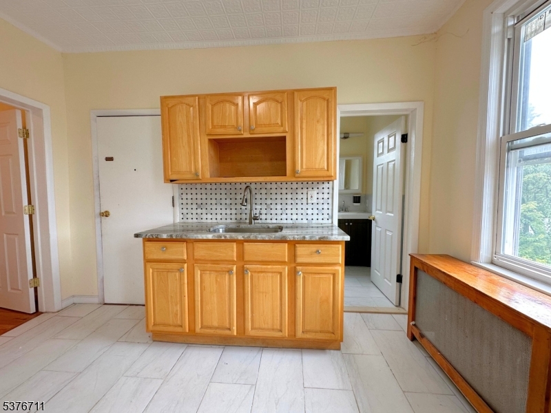 182 Knickerbocker Avenue, Unit 2 Paterson, NJ 07503 - Photo 5 of 14 a bathroom with a sink and a mirror
