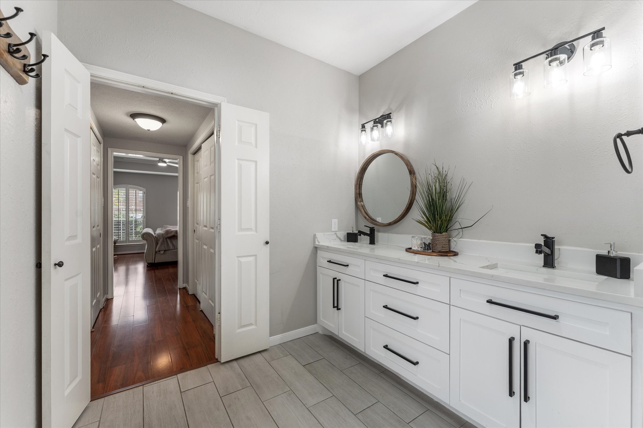 4318 Raintree Court Pasadena, TX 77505 - Photo 22 of 36 a bathroom with a double vanity sink and a mirror