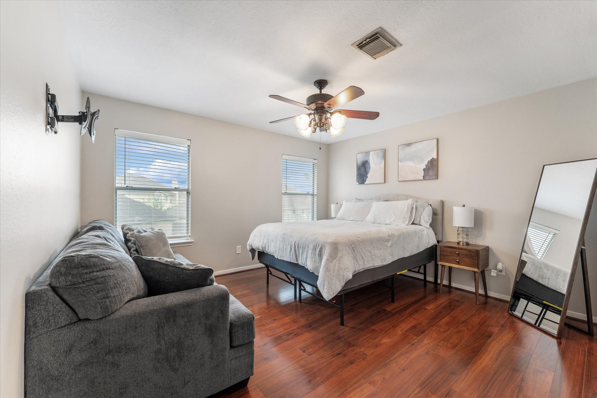 4318 Raintree Court Pasadena, TX 77505 - Photo 26 of 36 a spacious bedroom with a bed a couch and a chandelier