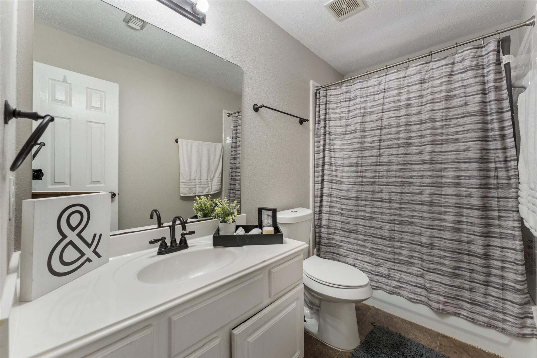 4318 Raintree Court Pasadena, TX 77505 - Photo 28 of 36 a bathroom with a toilet a sink and mirror