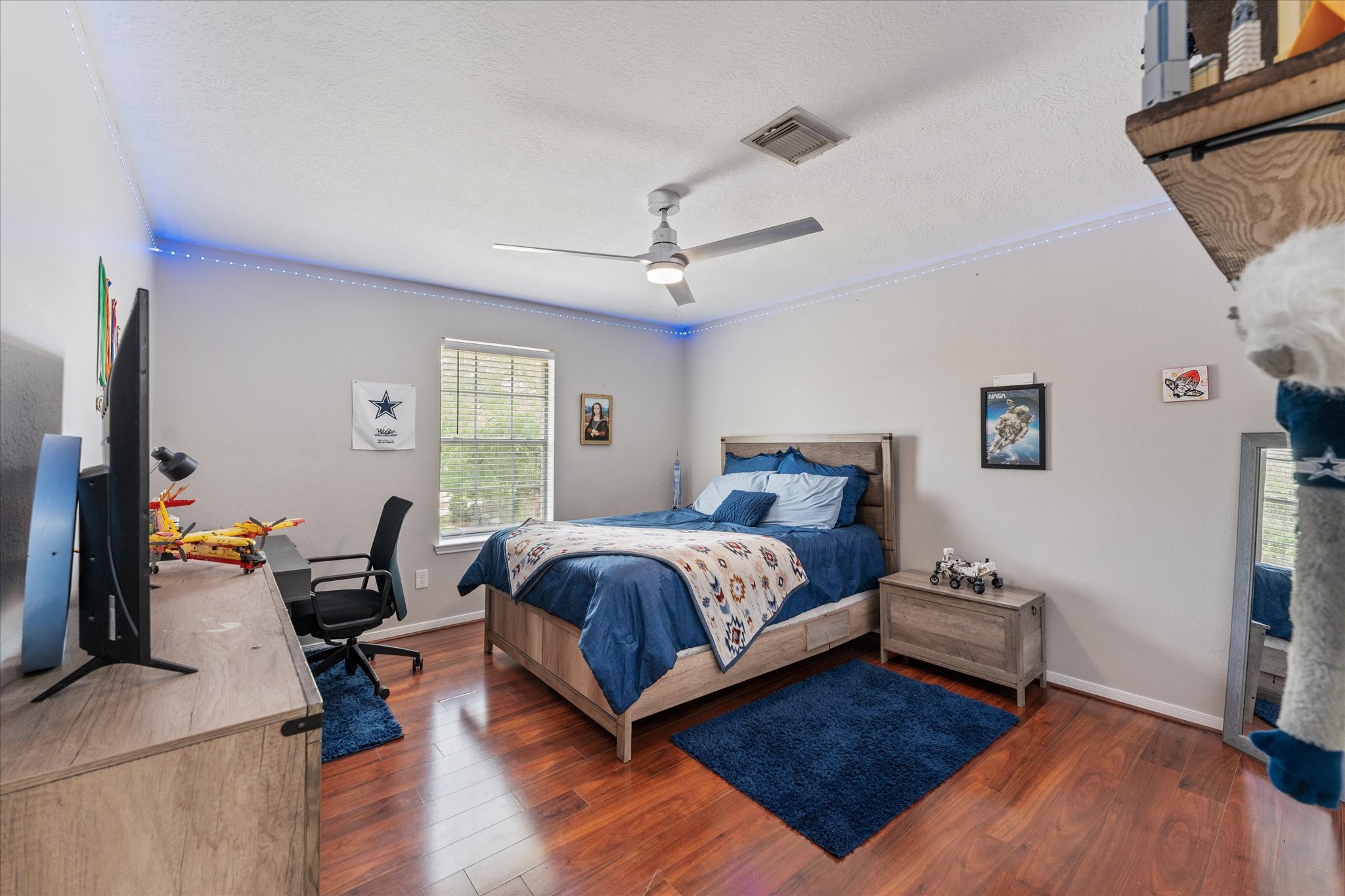 4318 Raintree Court Pasadena, TX 77505 - Photo 29 of 36 a spacious bedroom with a bed a couch and a window