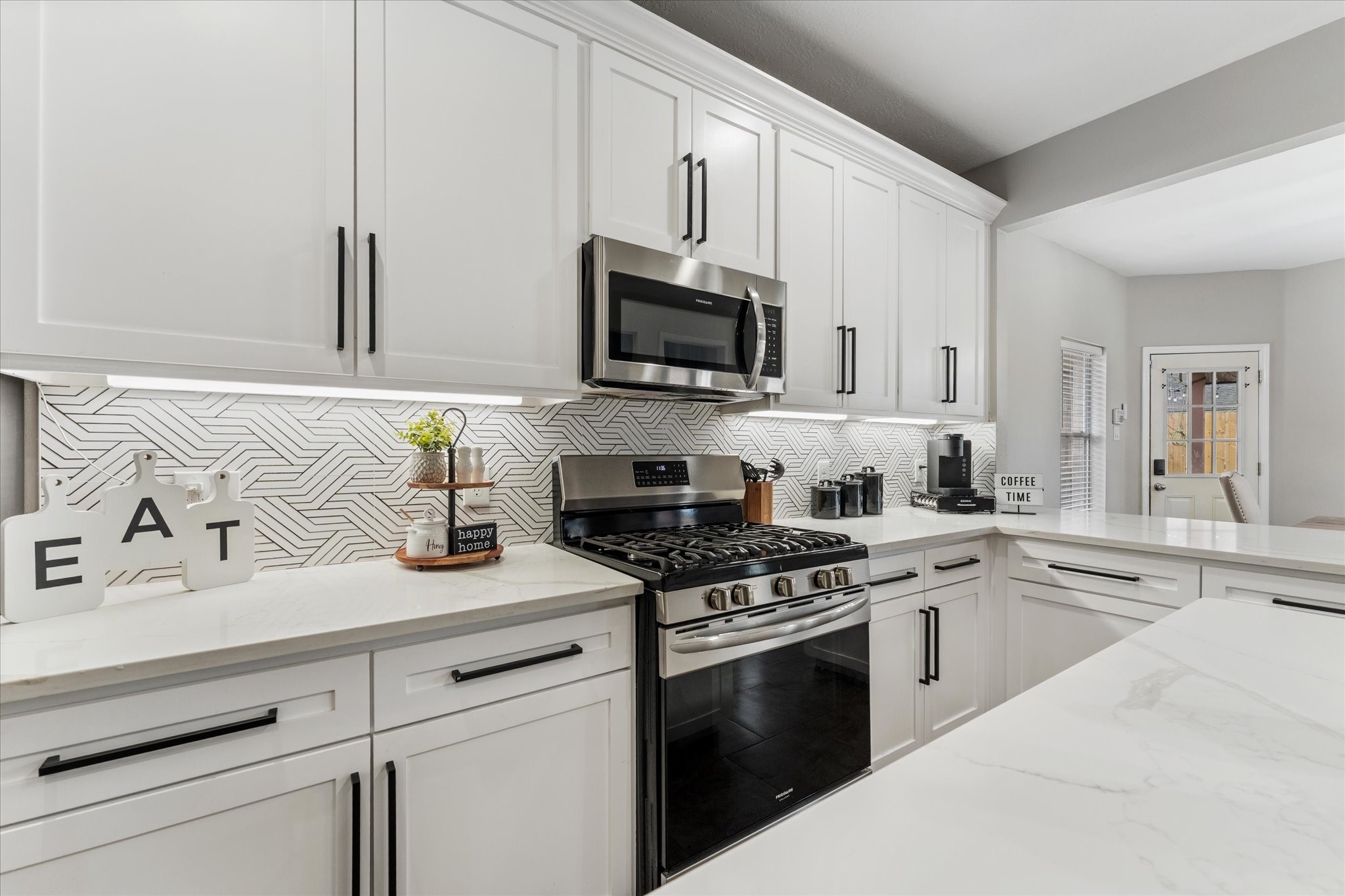 4318 Raintree Court Pasadena, TX 77505 - Photo 3 of 36 a kitchen with granite countertop a sink stove and microwave