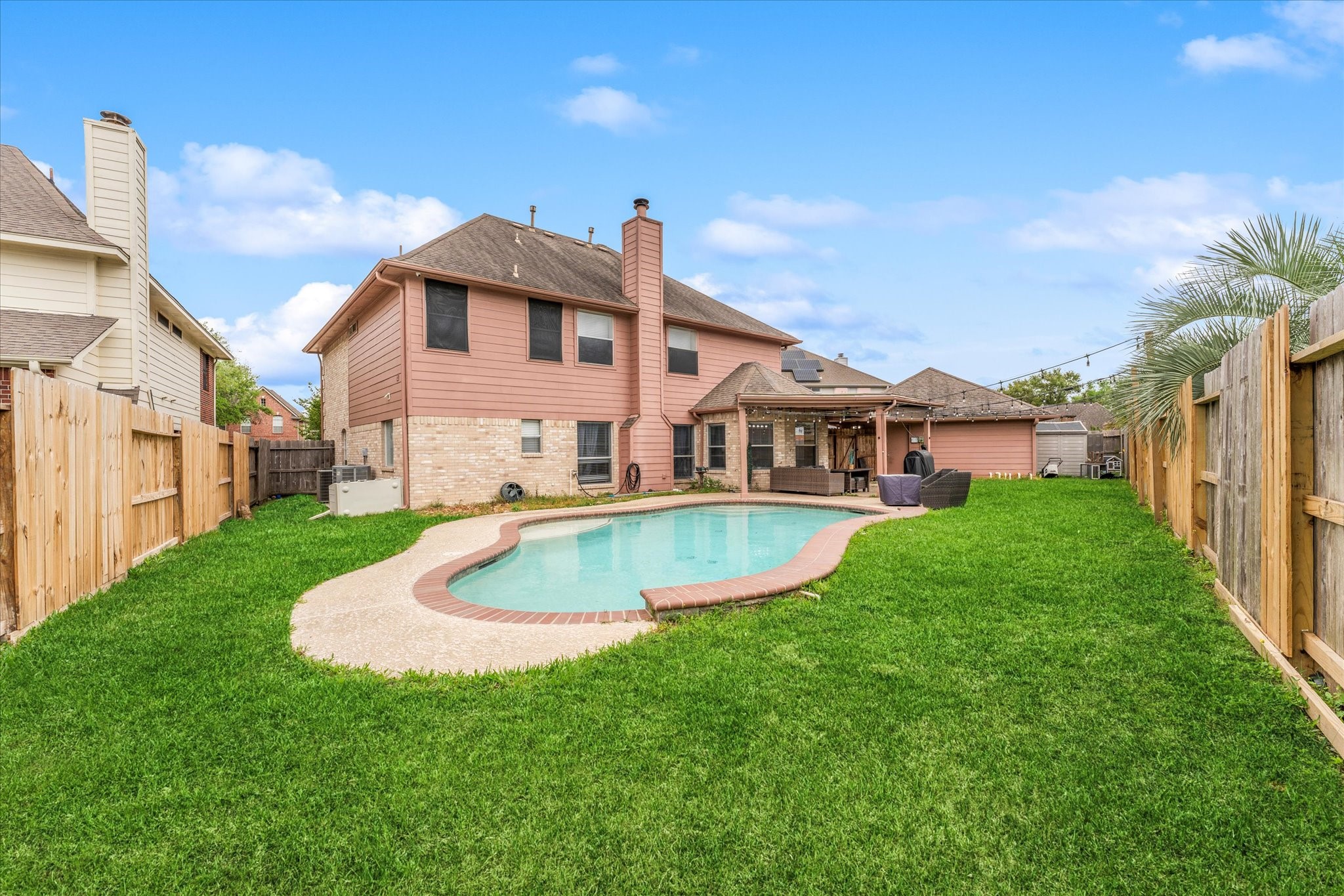 4318 Raintree Court Pasadena, TX 77505 - Photo 36 of 36 a view of a house with a swimming pool and a yard