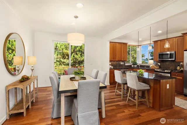 a kitchen with stainless steel appliances granite countertop a sink a stove and a refrigerator