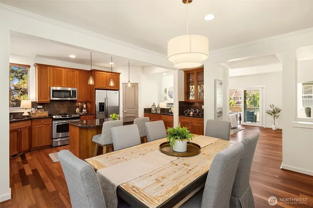 a kitchen with stainless steel appliances granite countertop sink stove top oven and cabinets