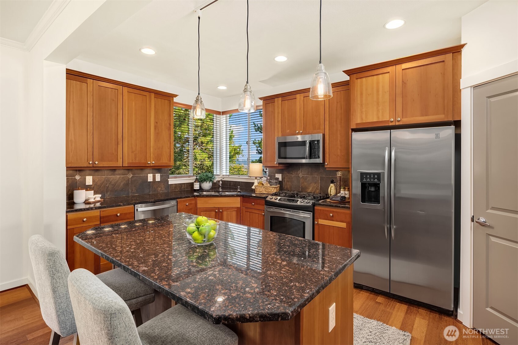 597 Alpine Ridge Place Northwest Issaquah, WA 98027 - Photo 13 of 32 a kitchen with stainless steel appliances granite countertop a sink a stove and a refrigerator