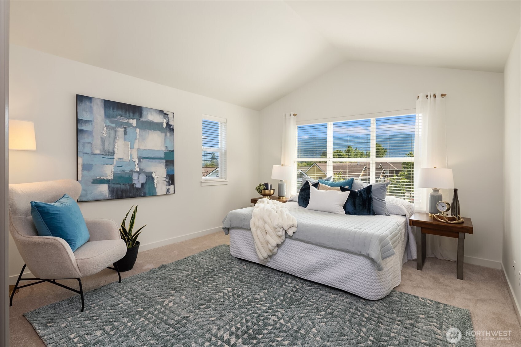 597 Alpine Ridge Place Northwest Issaquah, WA 98027 - Photo 18 of 32 a bedroom with a bed and wooden floor