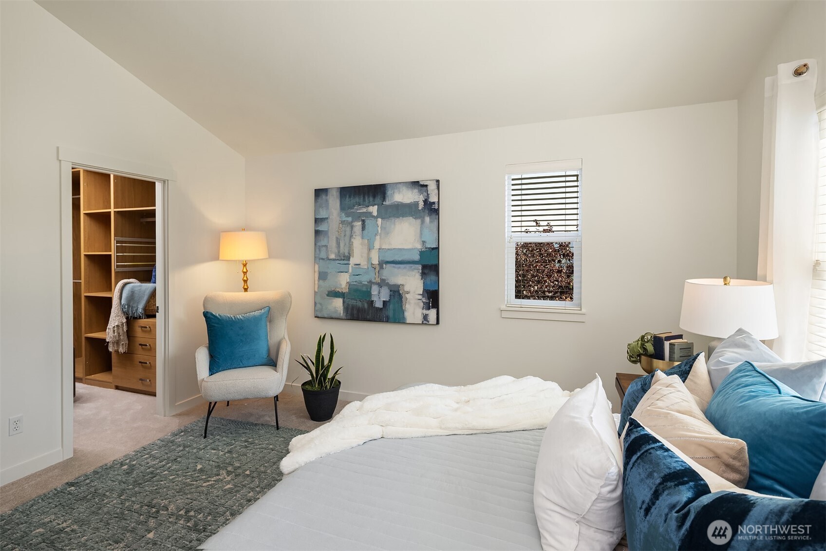 597 Alpine Ridge Place Northwest Issaquah, WA 98027 - Photo 19 of 32 a bedroom with furniture and a lamp
