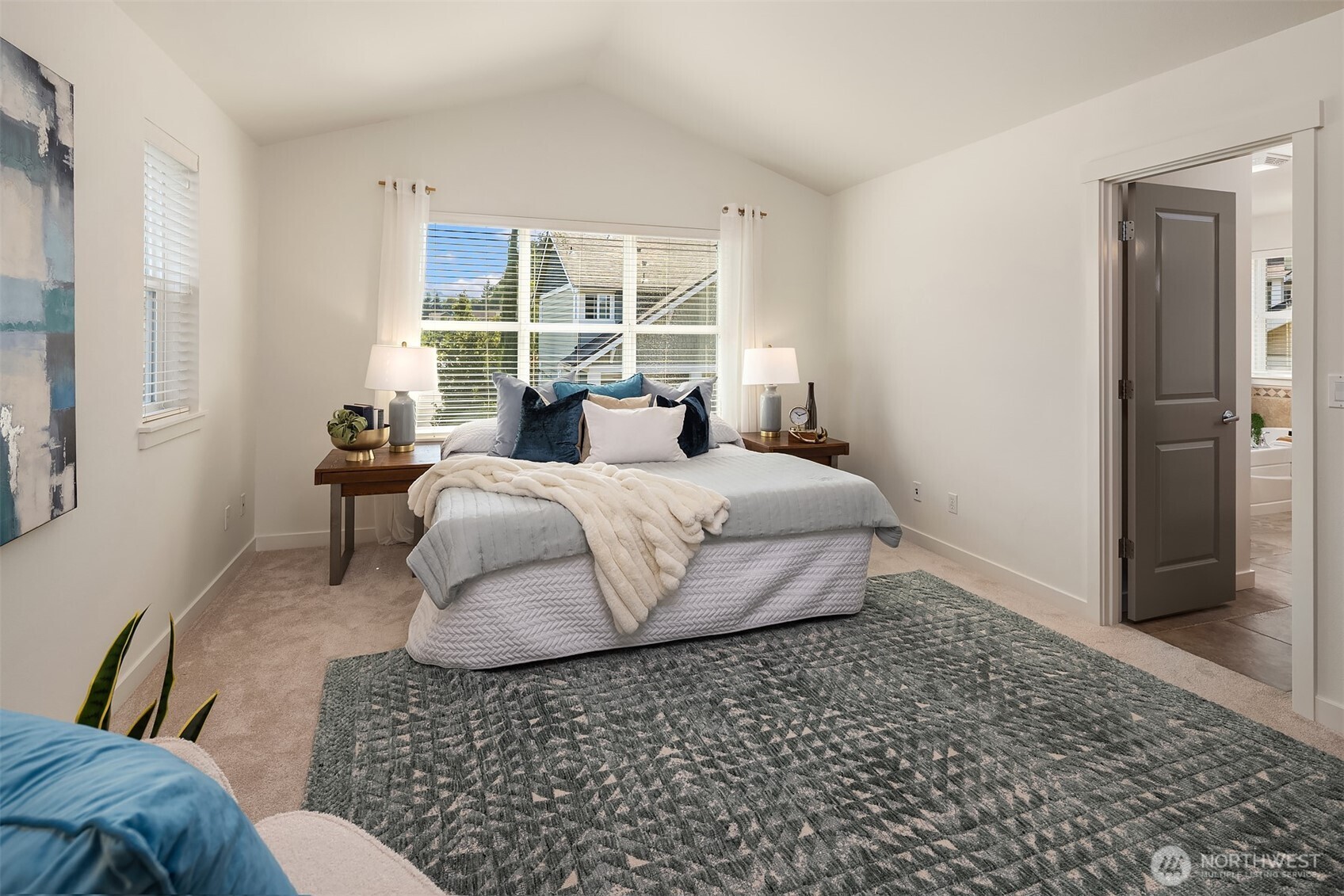 597 Alpine Ridge Place Northwest Issaquah, WA 98027 - Photo 21 of 32 a bedroom with a bed and wooden floor