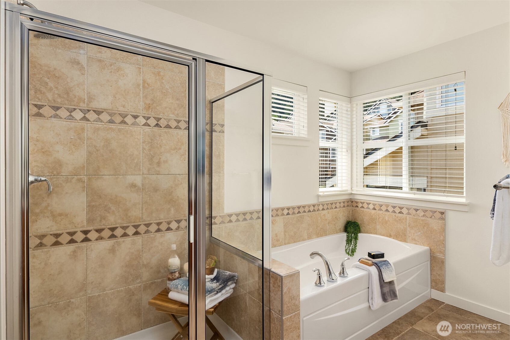 597 Alpine Ridge Place Northwest Issaquah, WA 98027 - Photo 23 of 32 a bathroom with a tub and a shower