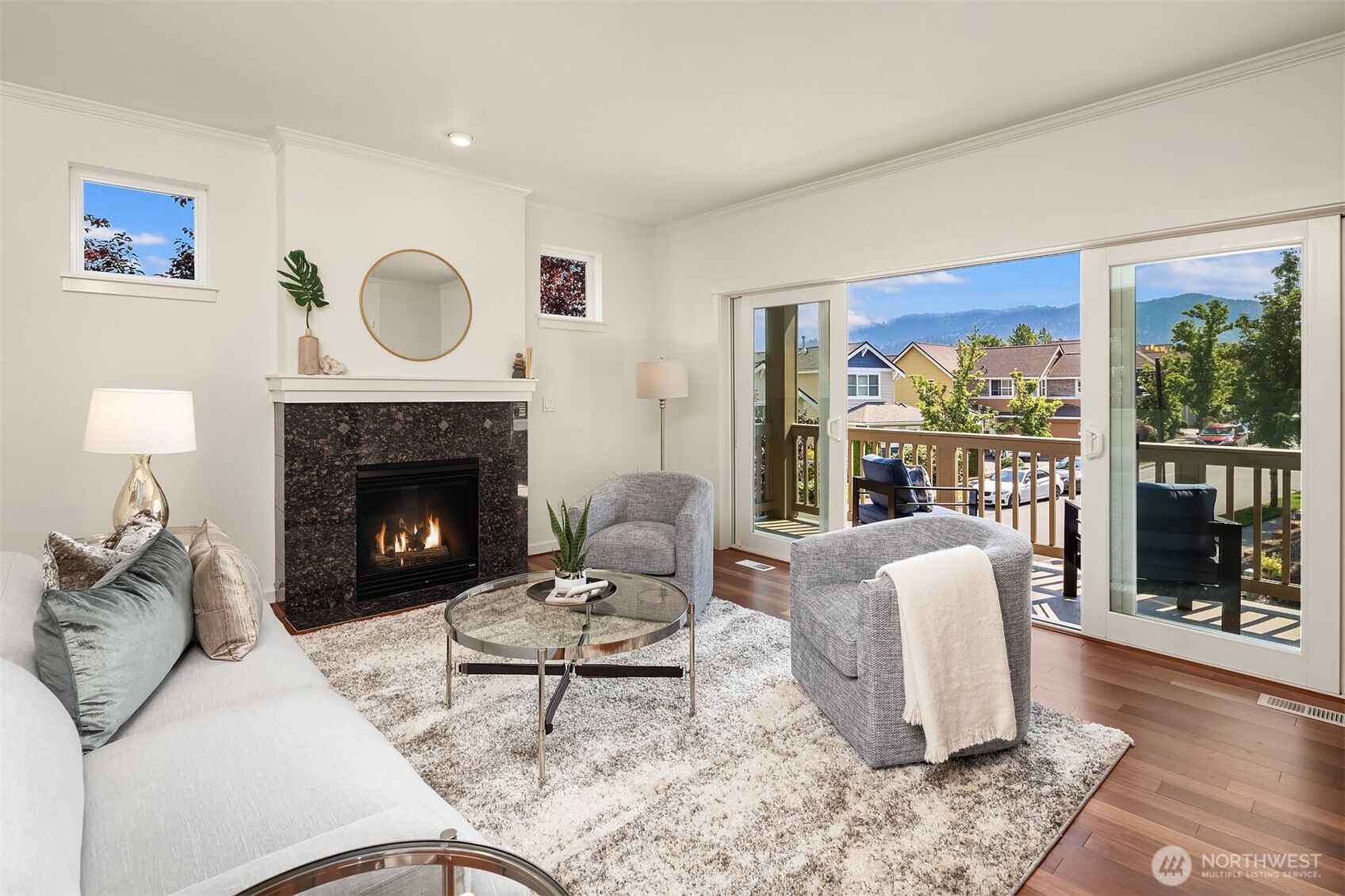 597 Alpine Ridge Place Northwest Issaquah, WA 98027 - Photo 6 of 32 a living room with furniture a rug a fireplace and a large window
