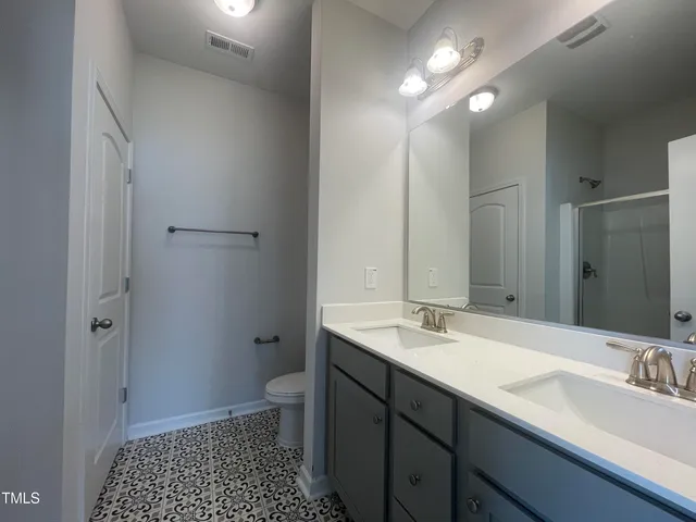 a bathroom with a shower and a sink