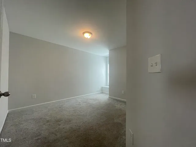 an empty room with closet area
