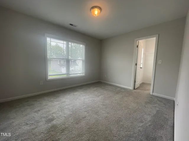 an empty room with a empty space and windows