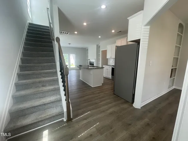 a view of entryway and hall with wooden floor