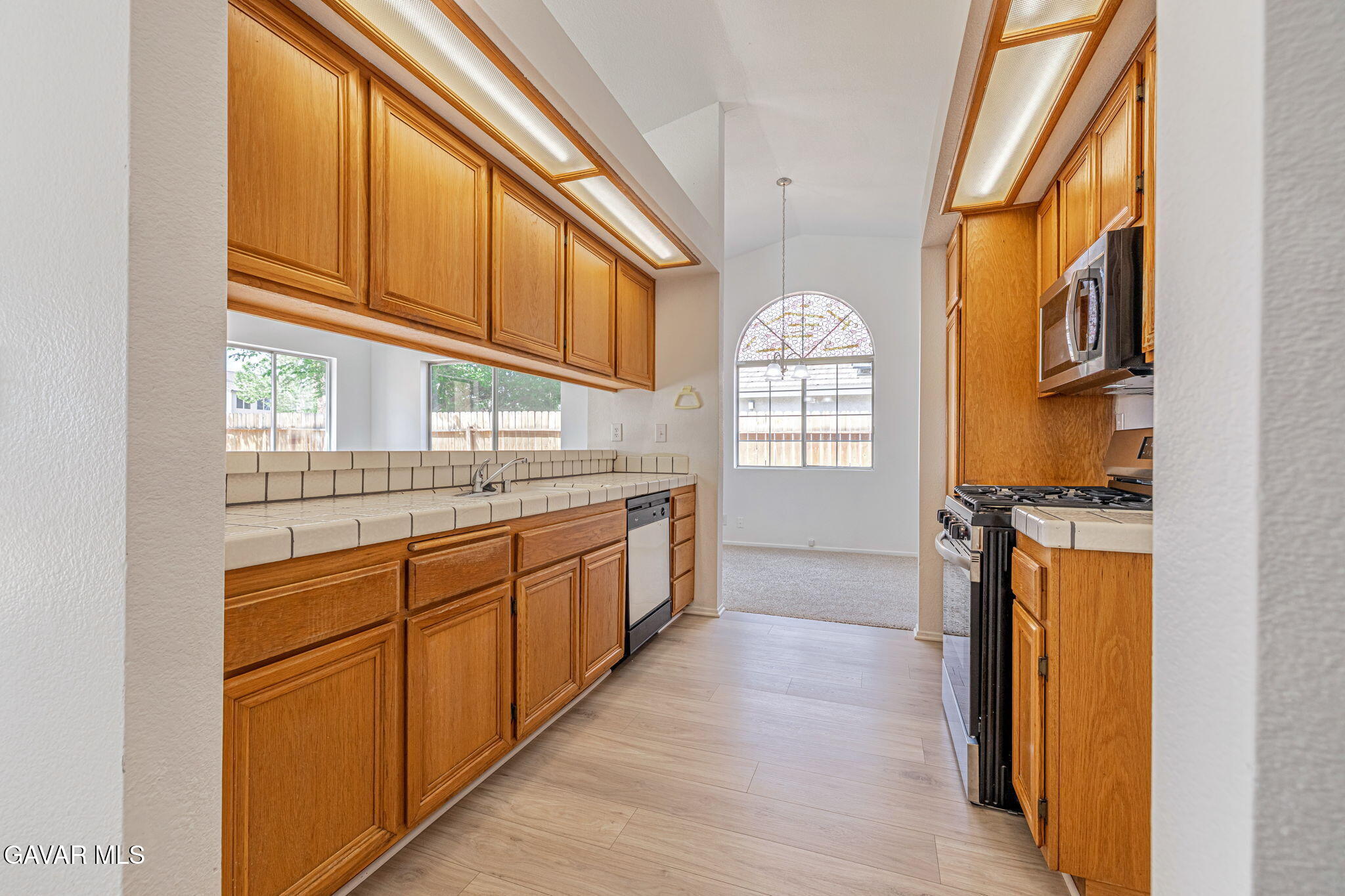2340 Lightcap Street Lancaster, CA 93535 - Photo 12 of 40 a kitchen with stainless steel appliances granite countertop a stove a sink and a refrigerator