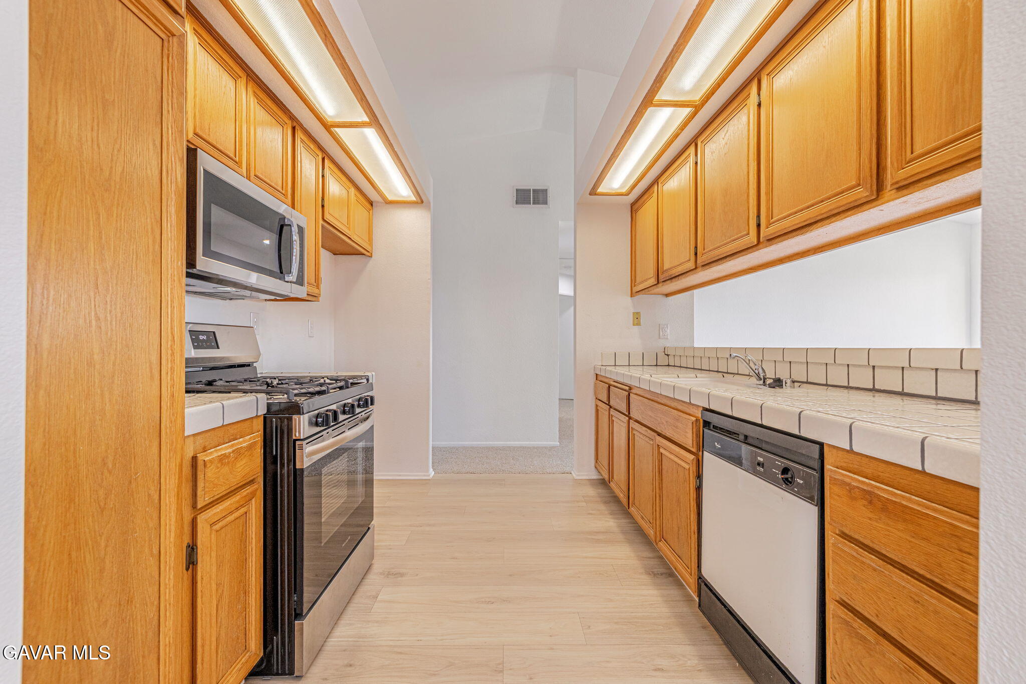2340 Lightcap Street Lancaster, CA 93535 - Photo 13 of 40 a kitchen with stainless steel appliances granite countertop a stove and a sink