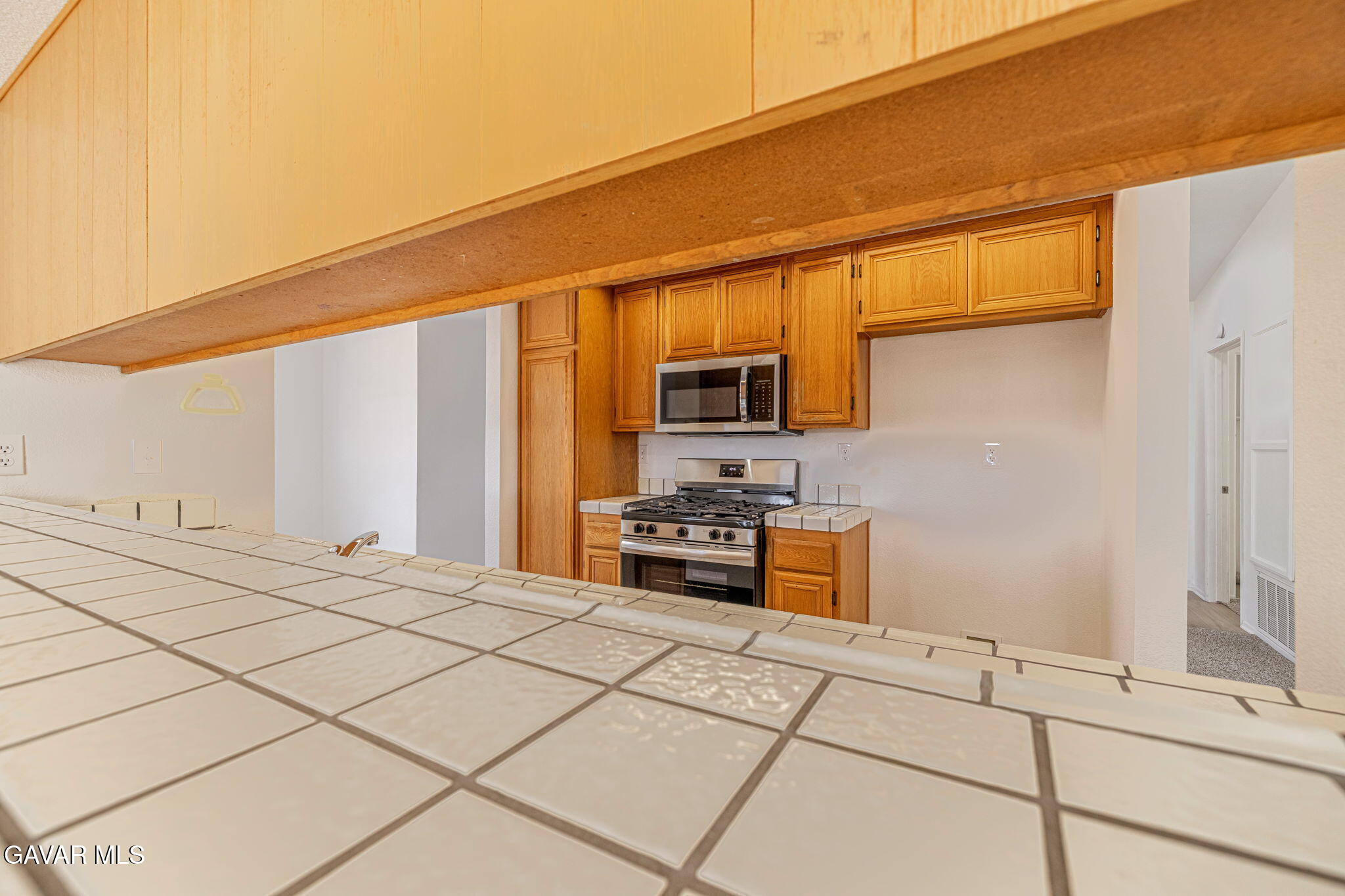2340 Lightcap Street Lancaster, CA 93535 - Photo 14 of 40 a kitchen with stainless steel appliances a stove a sink and a microwave