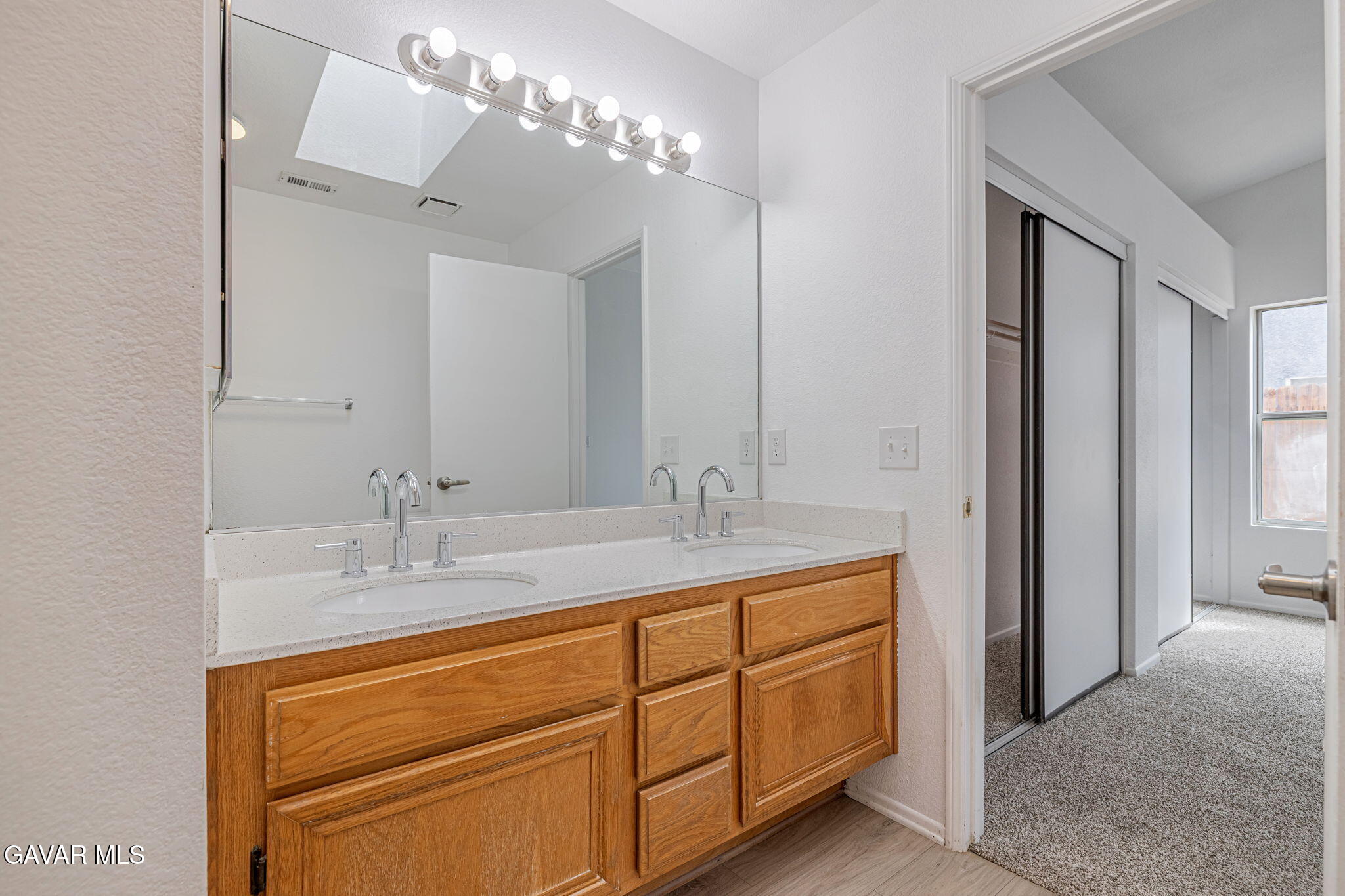 2340 Lightcap Street Lancaster, CA 93535 - Photo 23 of 40 a bathroom with a double vanity sink and a mirror