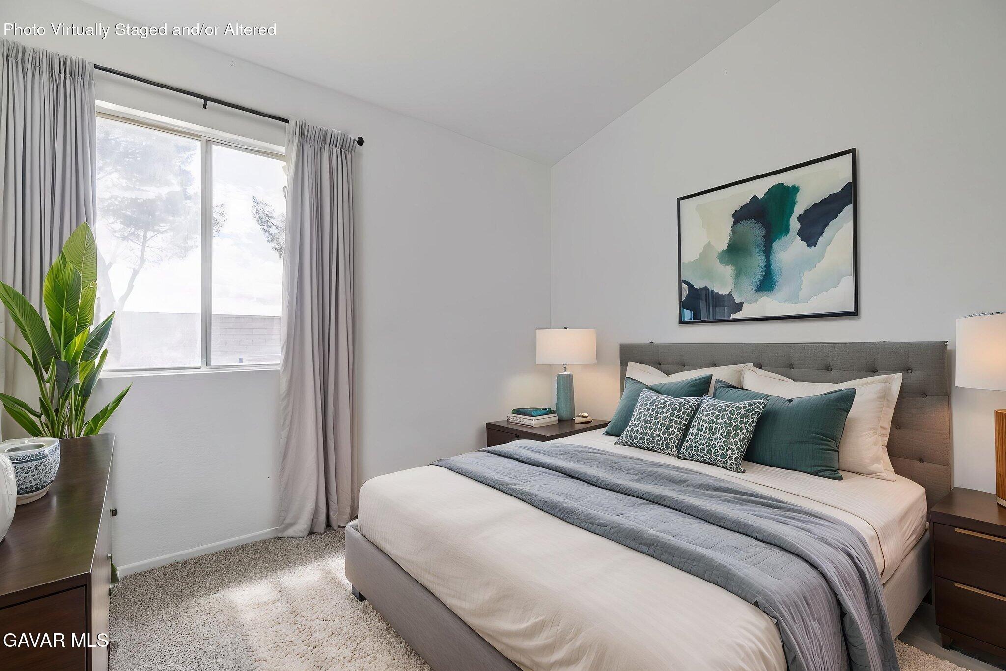 2340 Lightcap Street Lancaster, CA 93535 - Photo 28 of 40 a bedroom with a large bed and a potted plant