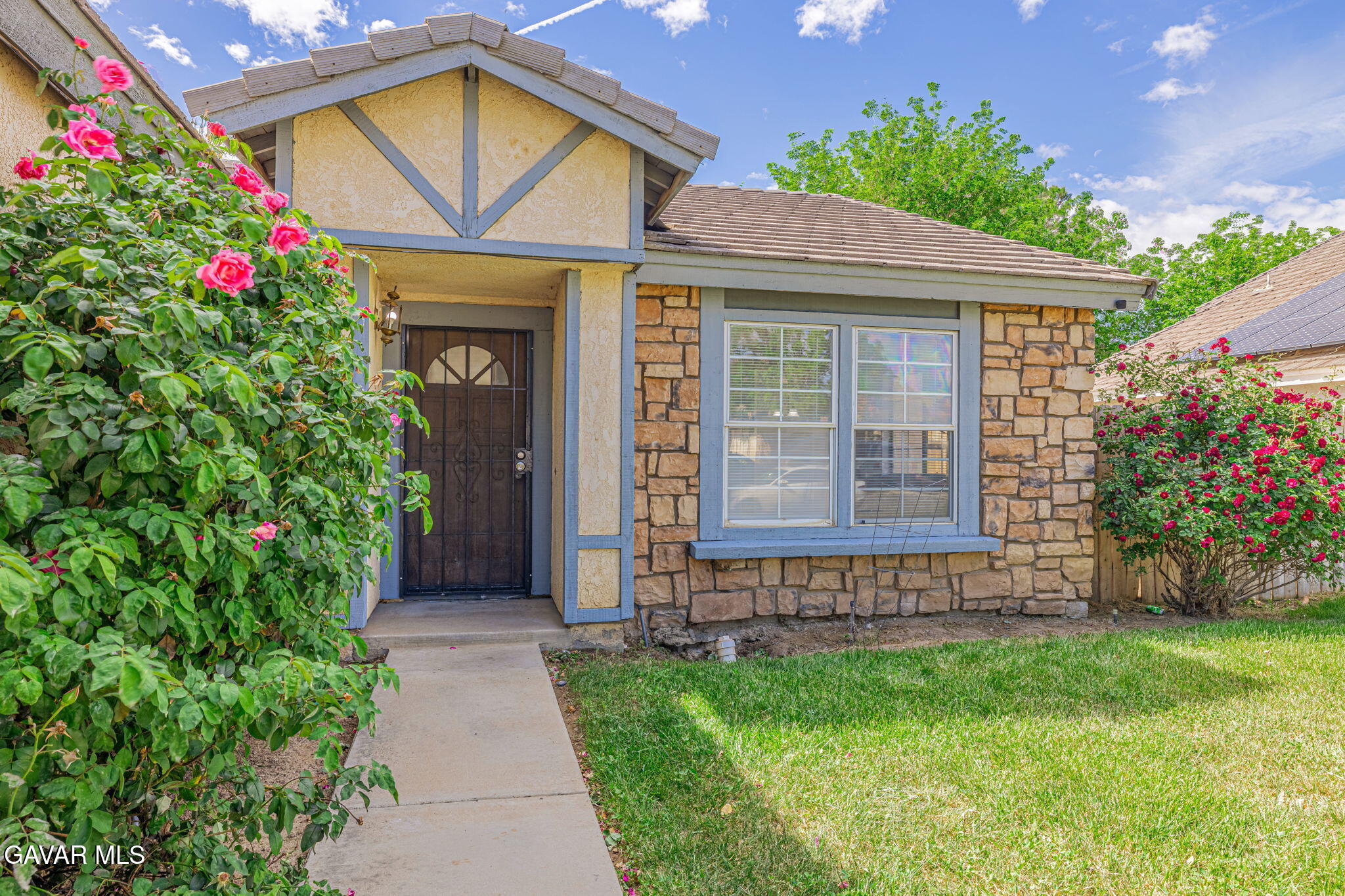 2340 Lightcap Street Lancaster, CA 93535 - Photo 3 of 40 a front view of a house with a yard and potted plants