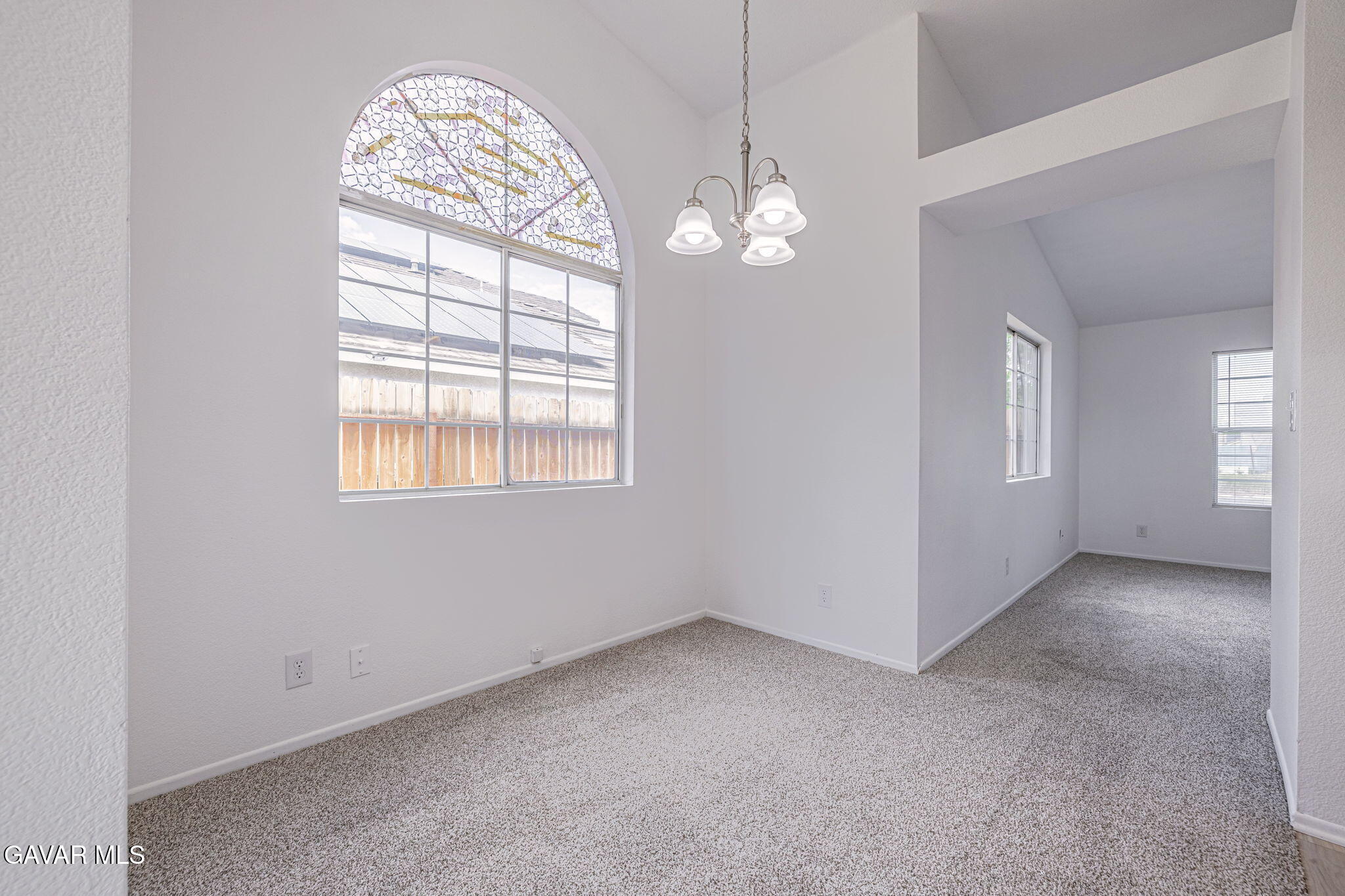 2340 Lightcap Street Lancaster, CA 93535 - Photo 10 of 40 an empty room with windows chandelier and fireplace