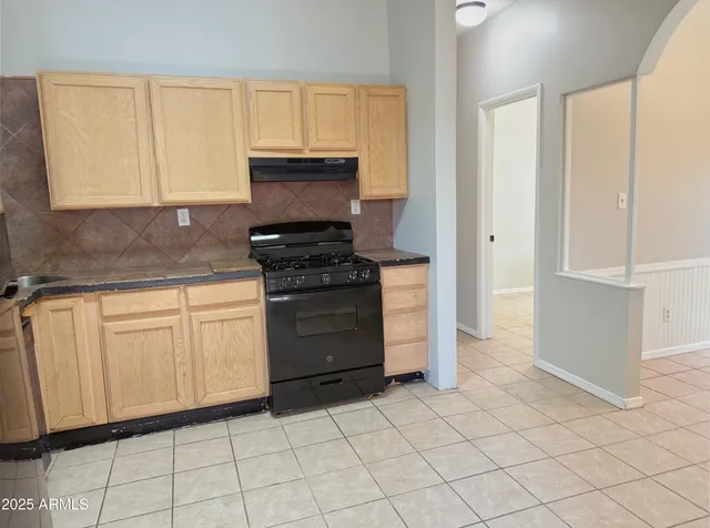 a kitchen with white cabinets and appliances