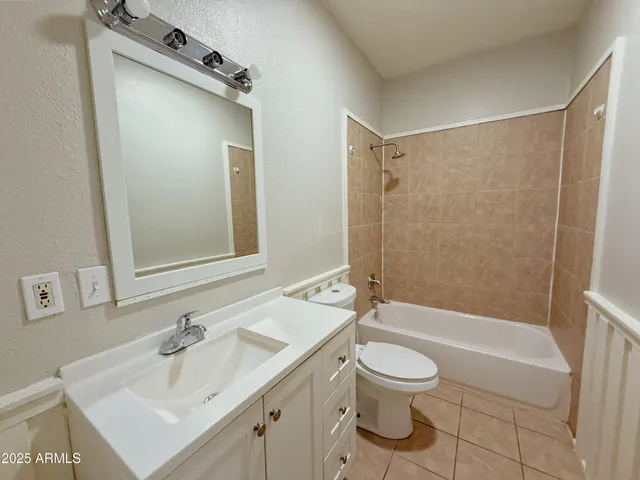 a bathroom with a sink toilet tub and shower