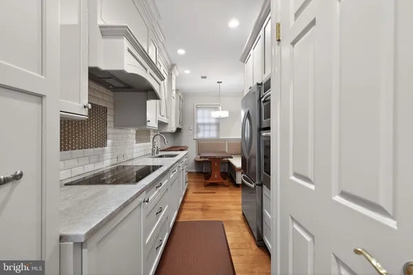 a kitchen with stainless steel appliances granite countertop a sink and a refrigerator