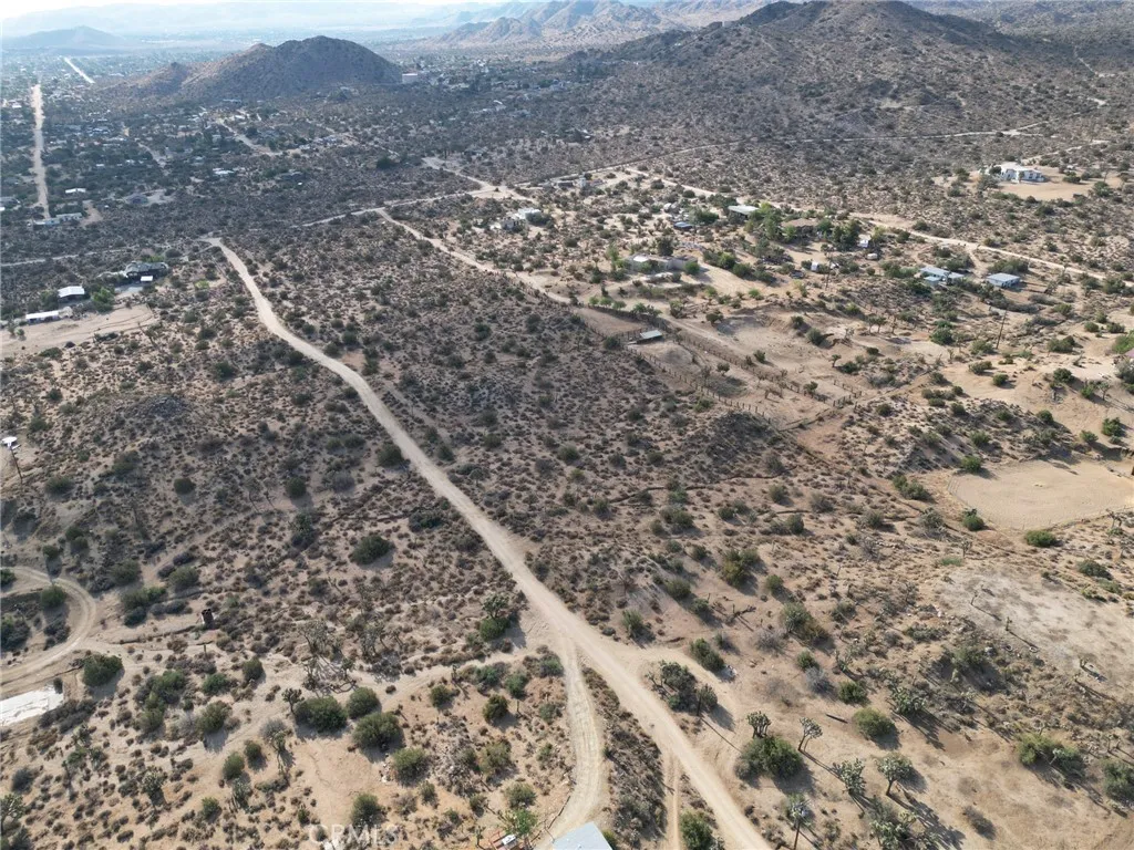 0 Kickapoo Yucca Valley Yucca Valley, CA 92284 - Photo 7 of 8 an aerial view of house with yard and mountain view in back