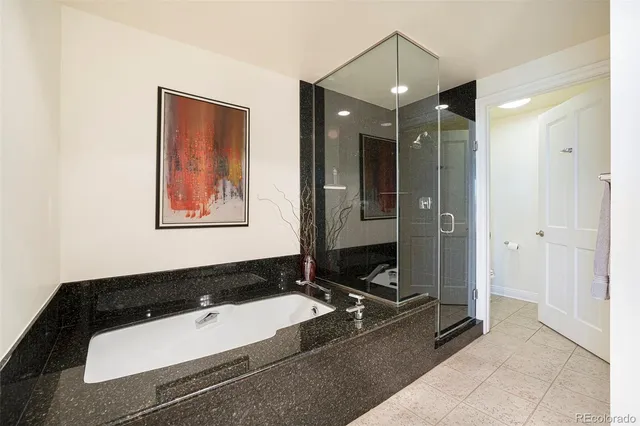 a room with pool table and two windows