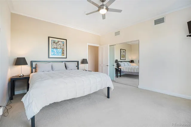 a spacious bedroom with a bed and a chandelier