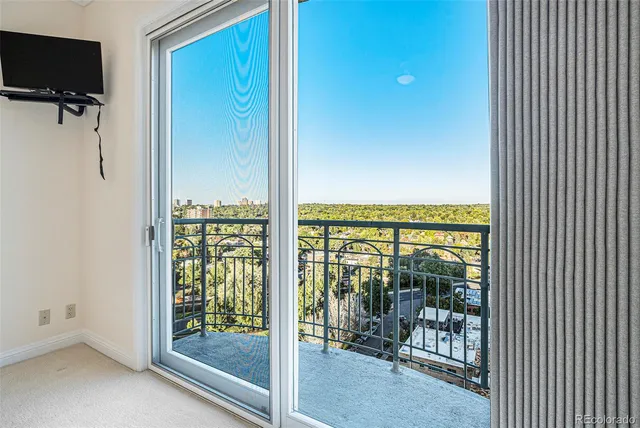 a view of a balcony with floor to ceiling window and floor to ceiling window