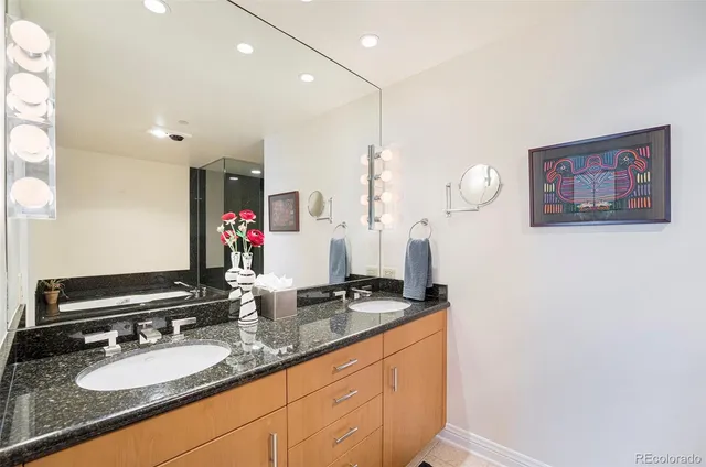 a bathroom with a sink double vanity and a mirror