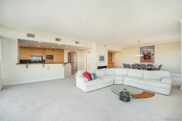 a living room with furniture and white walls