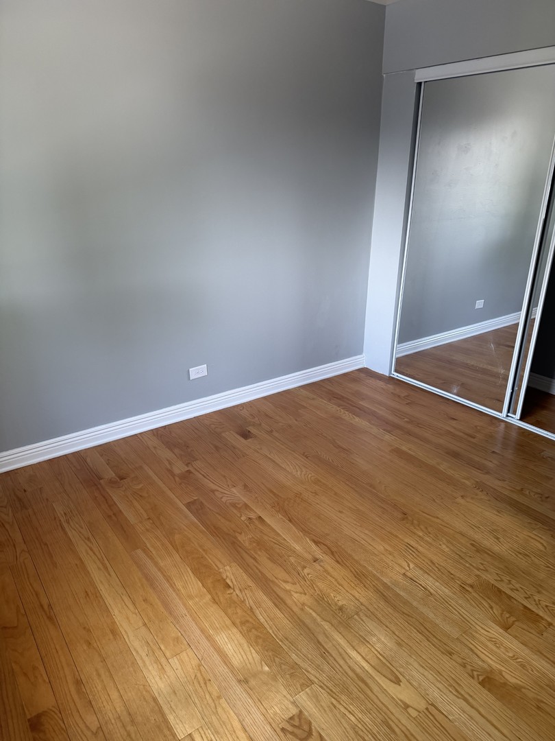606 Bridgeport Place Wheeling, IL 60090 - Photo 8 of 25 a view of an empty room with wooden floor
