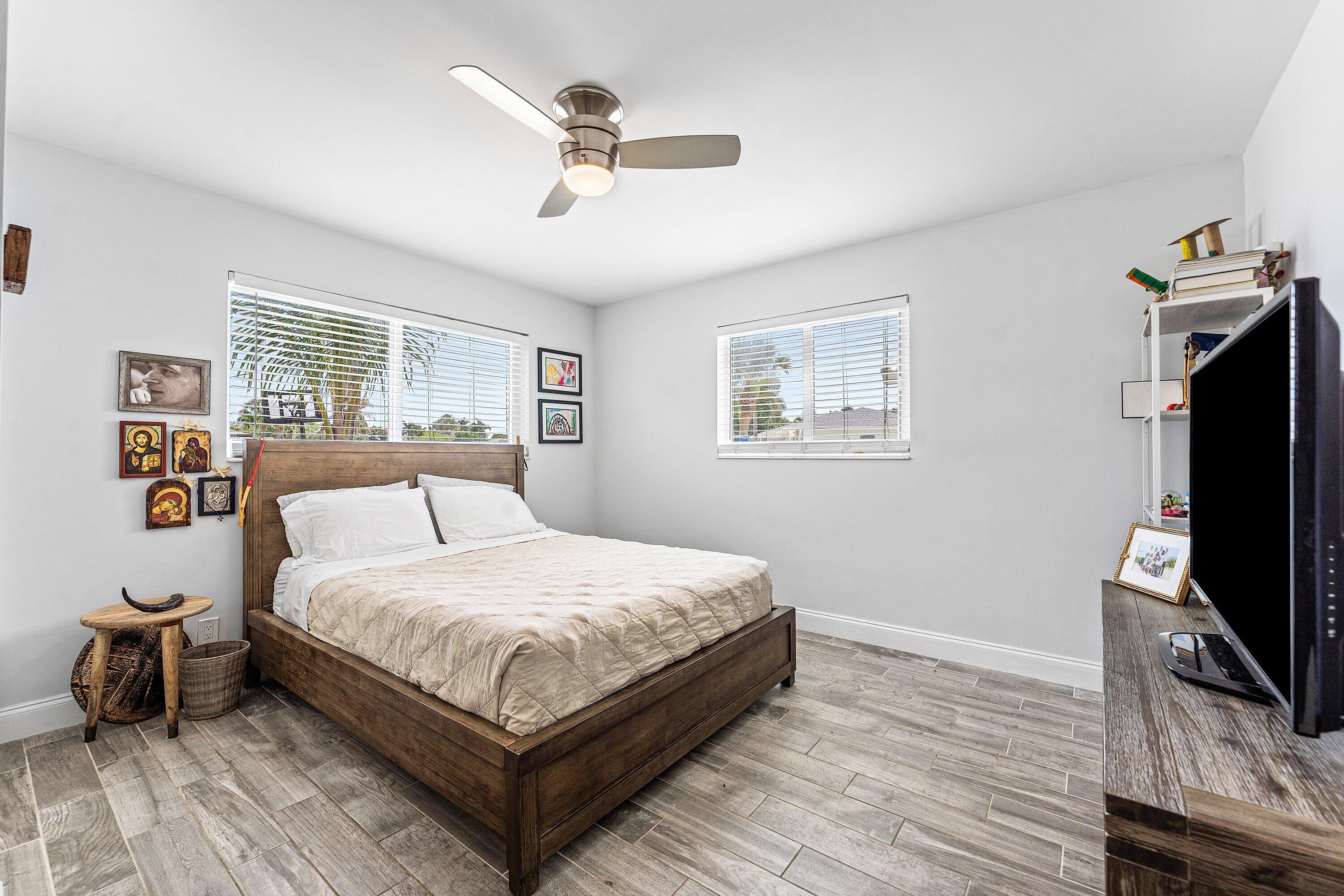 581 Northwest 13th Drive Boca Raton, FL 33486 - Photo 27 of 39 a bedroom with a bed flat screen tv and window