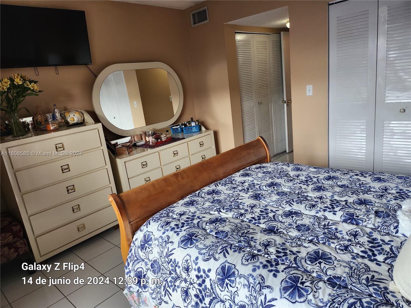 820 Southwest 105th Avenue, Unit 607 Miami, FL 33174 - Photo 12 of 22 a bedroom with a bed and a dresser
