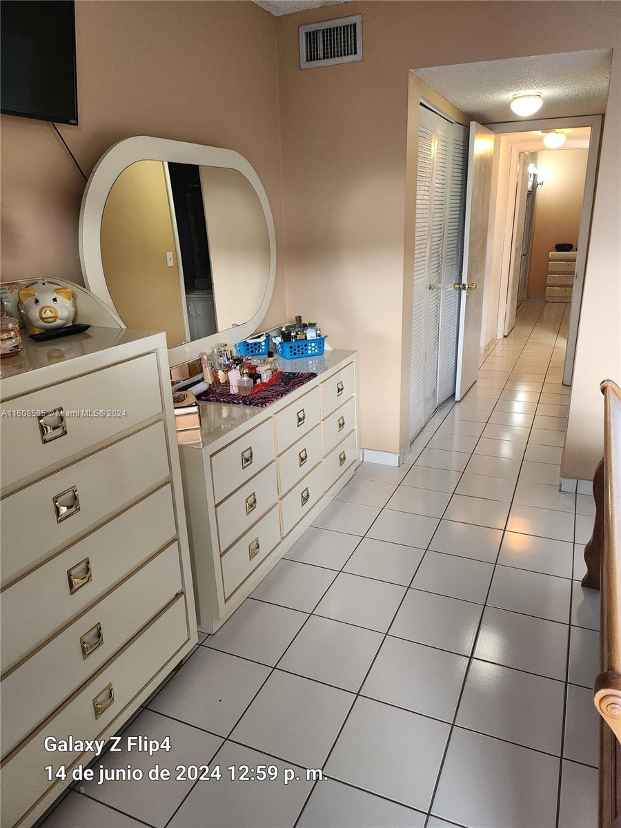 820 Southwest 105th Avenue, Unit 607 Miami, FL 33174 - Photo 13 of 22 a room with a mirror and vanity