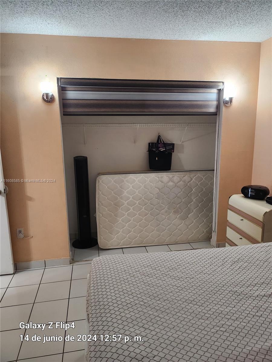 820 Southwest 105th Avenue, Unit 607 Miami, FL 33174 - Photo 15 of 22 a bedroom with a bed and a potted plant