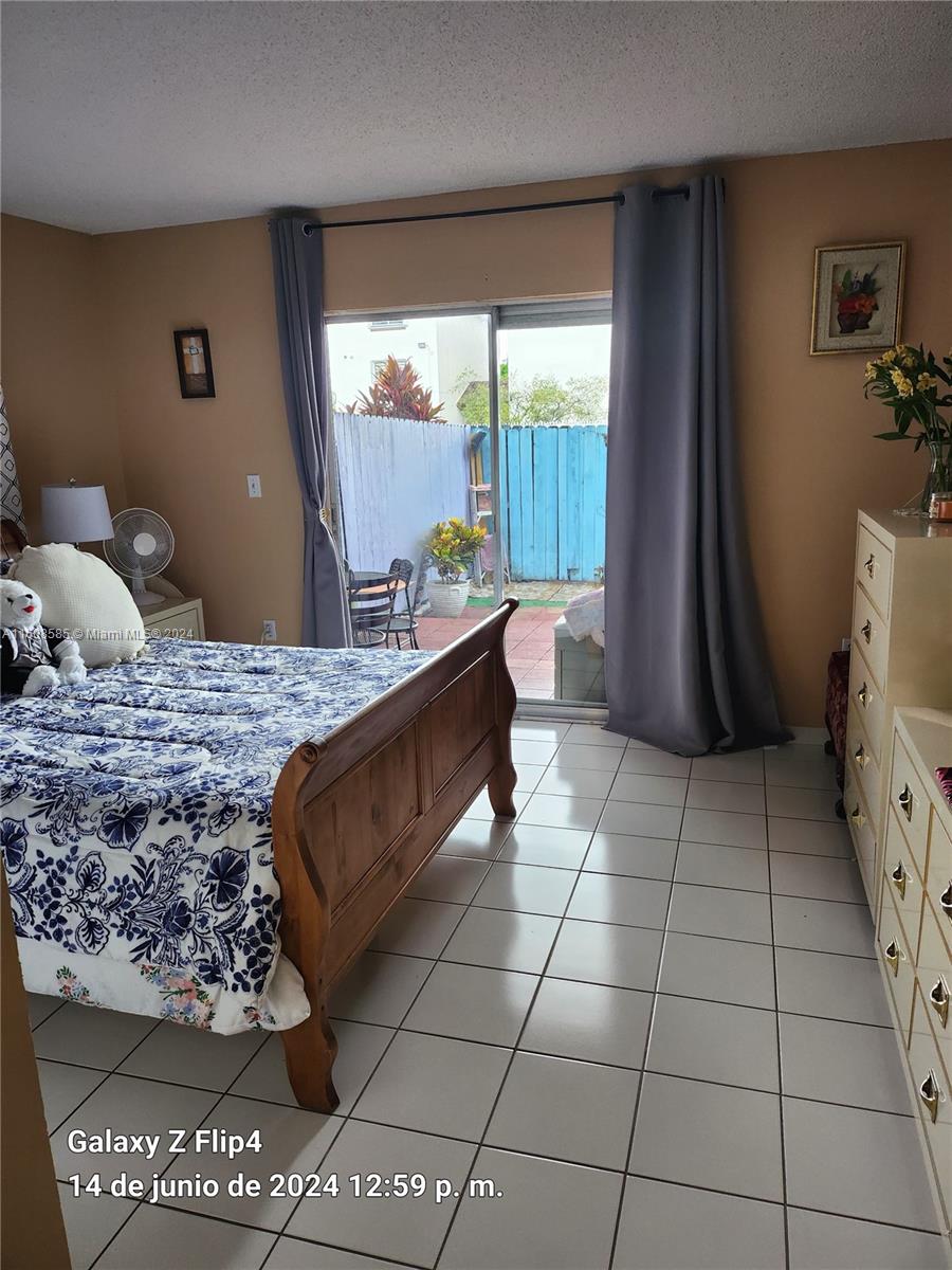 820 Southwest 105th Avenue, Unit 607 Miami, FL 33174 - Photo 10 of 22 a bedroom with a bed and a window