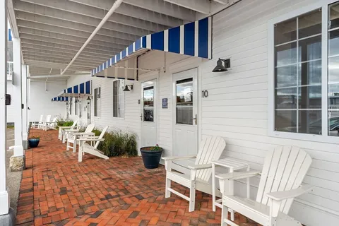 a view of a patio with table and chairs and potted plants