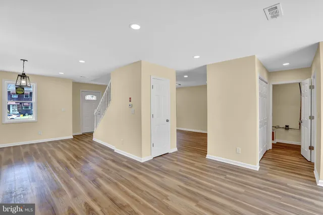 a kitchen with a sink a refrigerator and a stove top oven