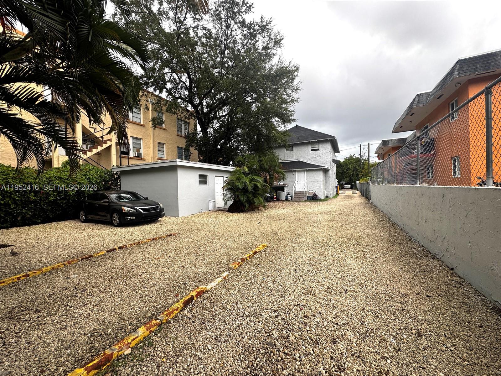 529 Southwest 3rd Street Miami, FL 33130 - Photo 3 of 12 a view of a white house with a large tree in front of it