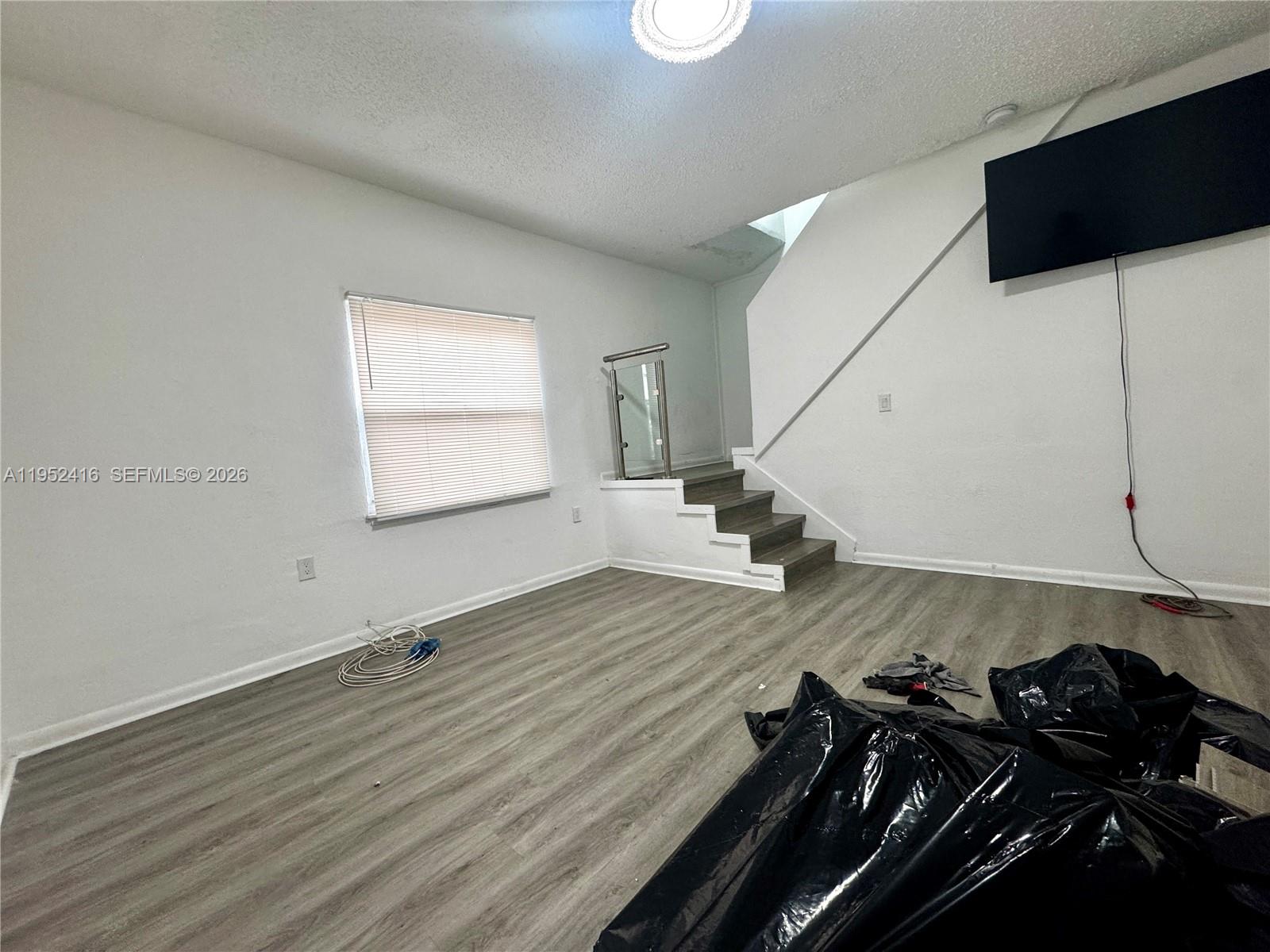 529 Southwest 3rd Street Miami, FL 33130 - Photo 6 of 12 a view of a room with wooden floor and utility room