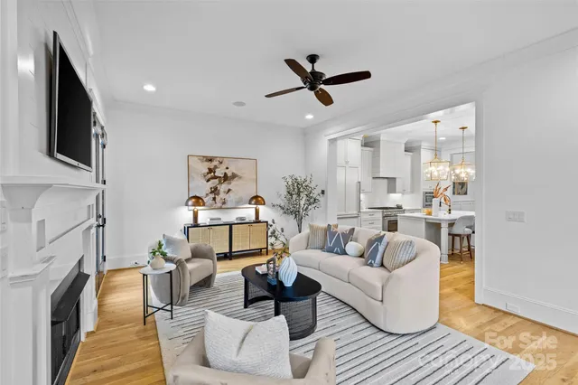 a living room with furniture fireplace and a large window